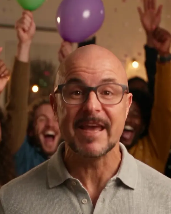 The same presenter at a birthday party with balloons and confetti